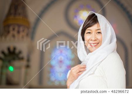 A woman gently smiling at the church 48296672