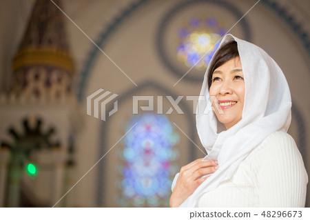 A woman gently smiling at the church 48296673