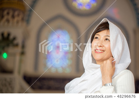 A woman gently smiling at the church 48296676