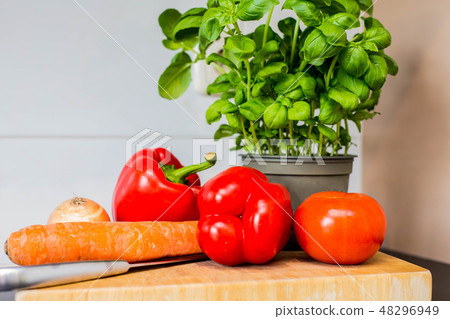 Vegetables Fresh coriander,carrot, paprika on the kitchen counter Vegetables Fresh coriander,carrot, paprika on the kitchen counter 48296949