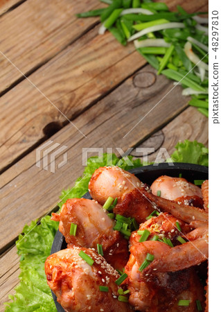 Roasted chicken legs and wings, wooden table . Roasted chicken legs and wings, wooden table . 48297810