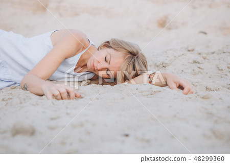 girl sundress lies sand sad crying longing 48299360