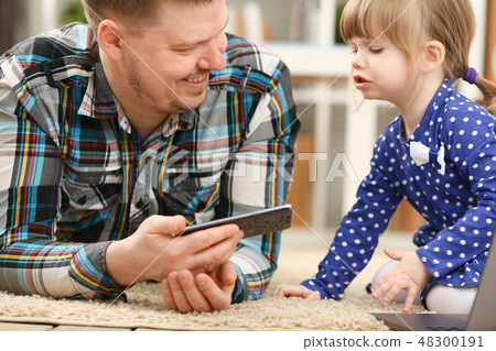 Cute little girl on floor carpet with dad Cute little girl on floor carpet with dad 48300191