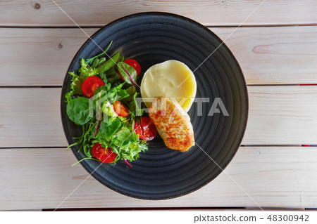 Fried chicken patty with mashed potato and spinach Fried chicken patty with mashed potato and spinach 48300942