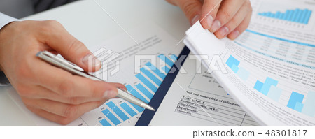 Male hands hold documents with financial 48301817