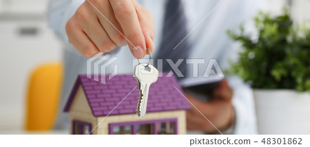 Male hand holds the key to the lock in the hand Male hand holds the key to the lock in the hand 48301862