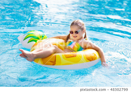 Child in swimming pool. Summer vacation with kids. Child in swimming pool. Summer vacation with kids. 48302799