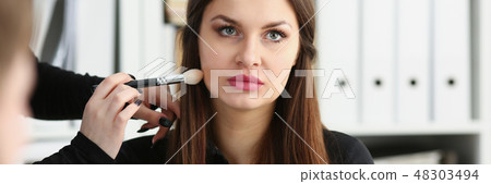 Beautiful brunette businesswoman hold in arm phone 48303494