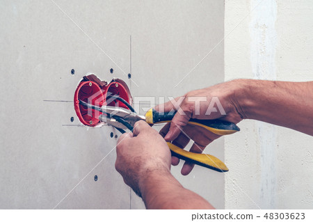 Man's hand repairing wall socket Man's hand repairing wall socket 48303623