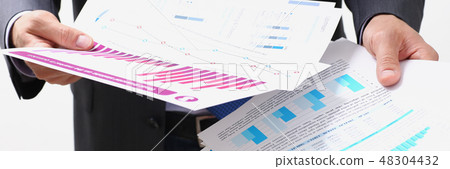 Male hand holding document with graph Male hand holding document with graph 48304432