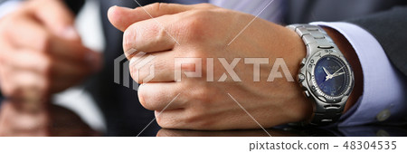 Man in suit and tie check out time at Man in suit and tie check out time at 48304535