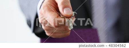 Male hand hold silver key giving Male hand hold silver key giving 48304562