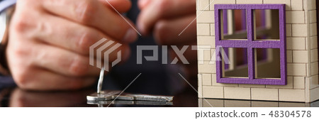 Man in suit and tie and silver key and little 48304578