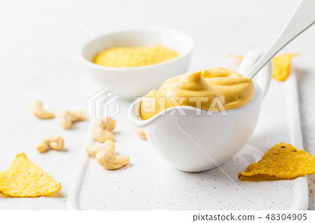 Vegan Cashew Cheese Sauce in white sauceboat 48304905