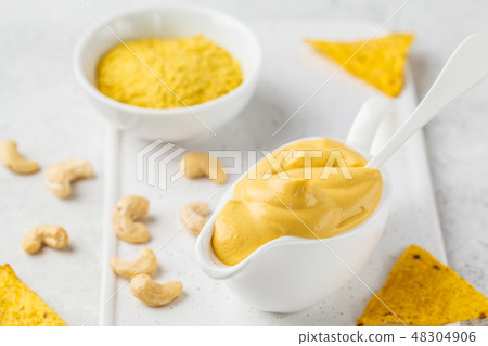Vegan Cashew Cheese Sauce in white sauceboat Vegan Cashew Cheese Sauce in white sauceboat 48304906