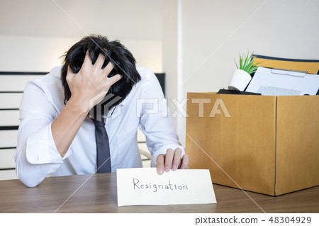 Stressed businessman will being resignation and packing belongin Stressed businessman will being resignation and packing belongin 48304929