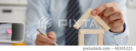 Male hand holds the key to the lock in the hand 48305225