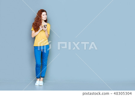 Attractive young woman using her phone 48305304