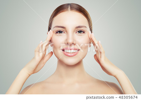 Beautiful woman touching her face in eyes area 48305674