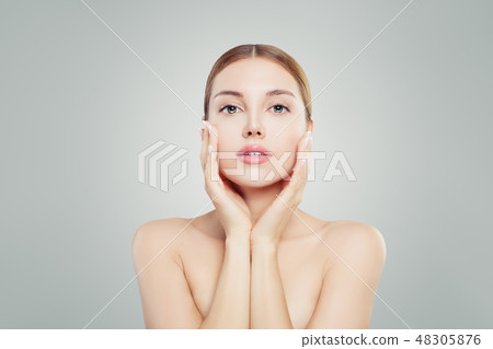 Beautiful model woman touching her face Beautiful model woman touching her face 48305876