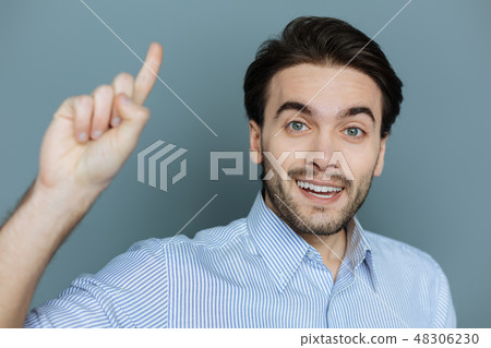 Cheerful pleasant man finding a solution to the problem 48306230