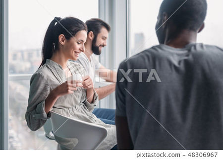 Multi-cultural colleagues are joking during coffee break at workplace 48306967