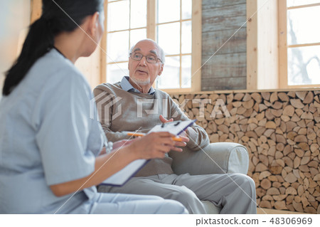 Professional doctor listening to senior mans complaint Professional doctor listening to senior mans complaint 48306969