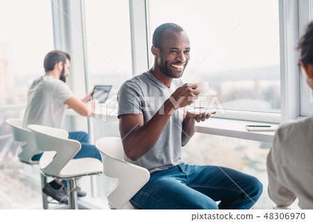 Multi-cultural colleagues are joking during coffee break at workplace Multi-cultural colleagues are joking during coffee break at workplace 48306970
