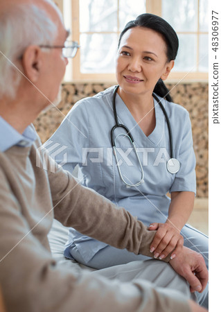 Glad doctor worrying about senior man 48306977