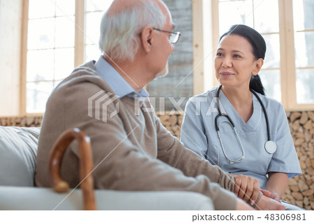 Positive doctor treating senior man Positive doctor treating senior man 48306981