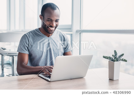 Young businessman working on his laptop in spacious bright office. 48306990