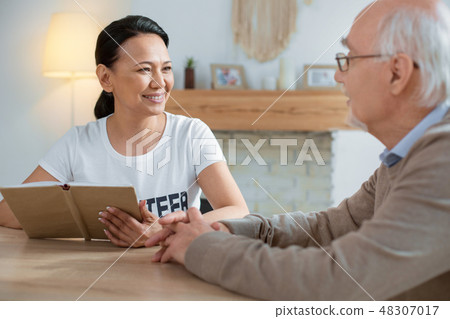 Beautiful volunteer admiring senior man Beautiful volunteer admiring senior man 48307017