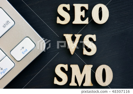 SEO vs SMO and keyboard on a dark desk. 48307116