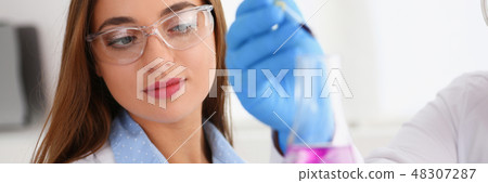 Technician hold in arms in protective gloves sample bottle Technician hold in arms in protective gloves sample bottle 48307287