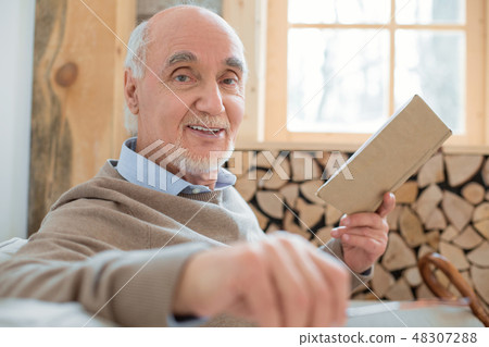 Satisfied senior man explaining book storyline Satisfied senior man explaining book storyline 48307288