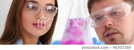 Technician hold in arms in protective gloves sample bottle Technician hold in arms in protective gloves sample bottle 48307289