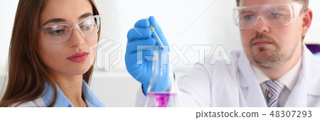 Technician hold in arms in protective gloves sample bottle Technician hold in arms in protective gloves sample bottle 48307293