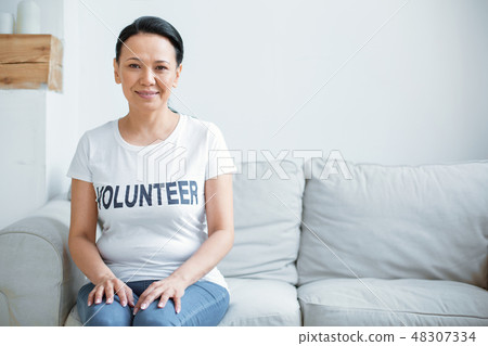 Beautiful female volunteer preparing for service Beautiful female volunteer preparing for service 48307334