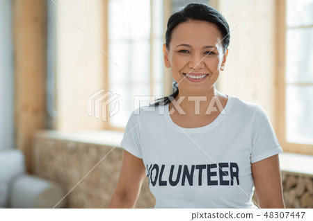 Cheerful female volunteer performing community service Cheerful female volunteer performing community service 48307447