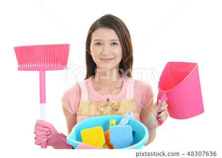 A smiling woman with a cleaning tool 48307636