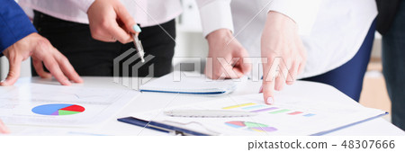 Female hand point silver pen to graph on seminar Female hand point silver pen to graph on seminar 48307666