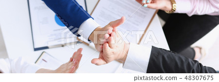 Group of people in suits crossed hands Group of people in suits crossed hands 48307675