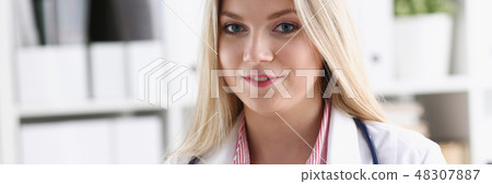 Beautiful smiling female doctor sit at workplace 48307887