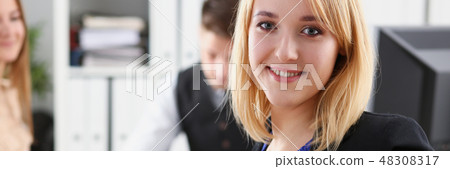 Beautiful smiling cheerful girl at workplace 48308317