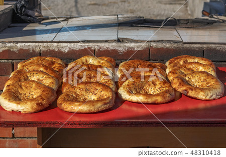 Central Asian tortillas on a street counter Central Asian tortillas on a street counter 48310418