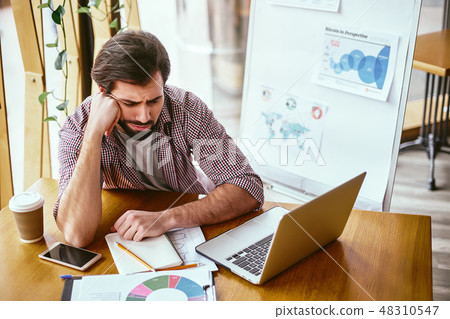 I am sick and tired of being sick and tired. Tired businessman sitiing with a laptop, smartphone and 48310547