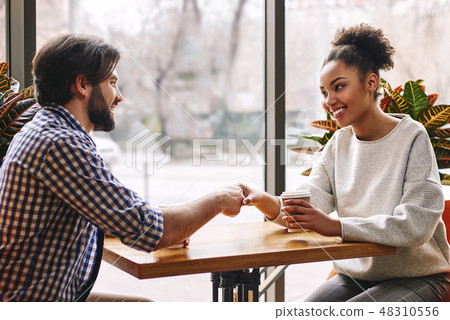 Deal! Portrait of business people shaking hands while having a lunch break at cafe Deal! Portrait of business people shaking hands while having a lunch break at cafe 48310556