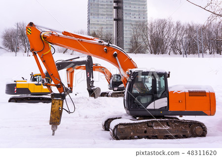 dance of excavators in the snow 48311620