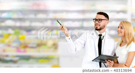 Doctor with patient pointing at empty copy space. Doctor with patient pointing at empty copy space. 48313694