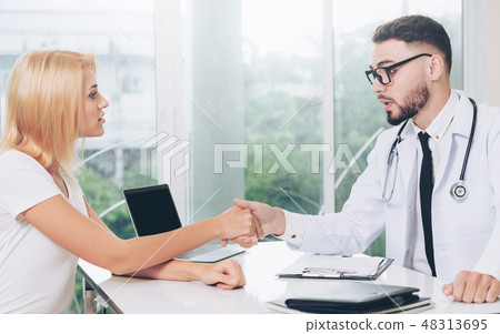 Male Doctor and Female Patient in Hospital Office Male Doctor and Female Patient in Hospital Office 48313695